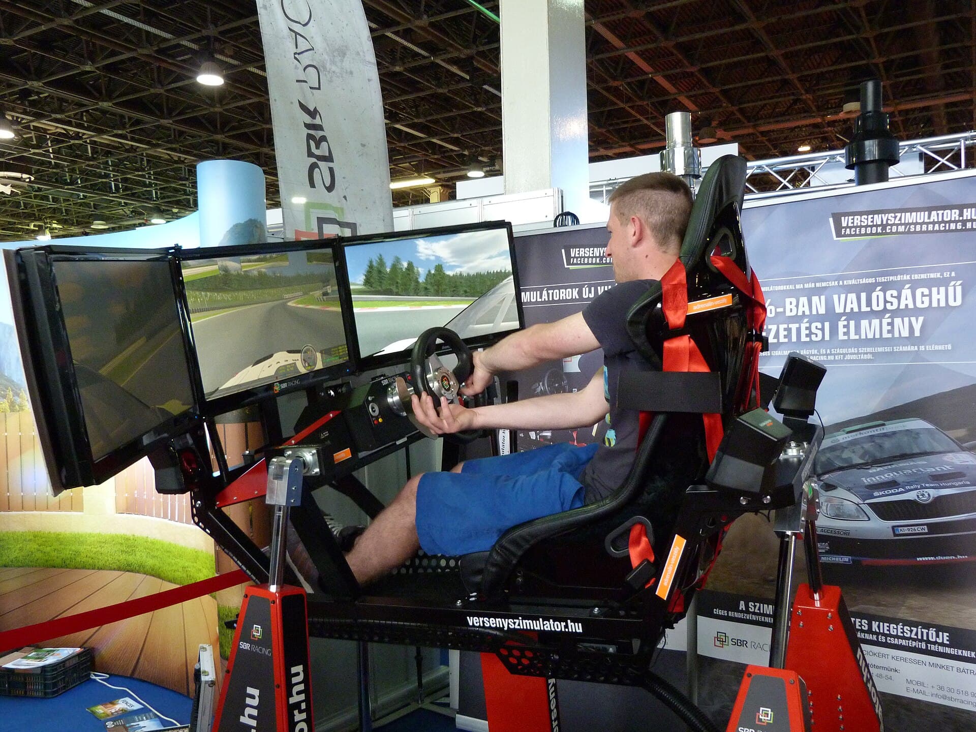 A racing simulator with a wheel, pedals and a racing seat